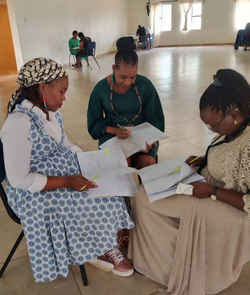 3 women sitting in a circle and studying.