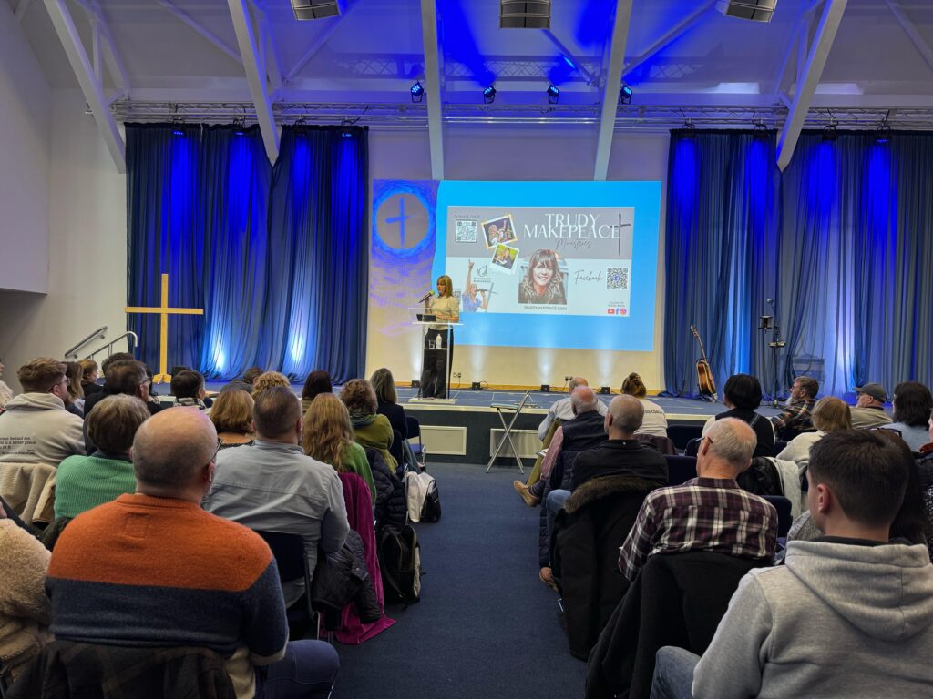 Picture of an audience and a speaker at the conference